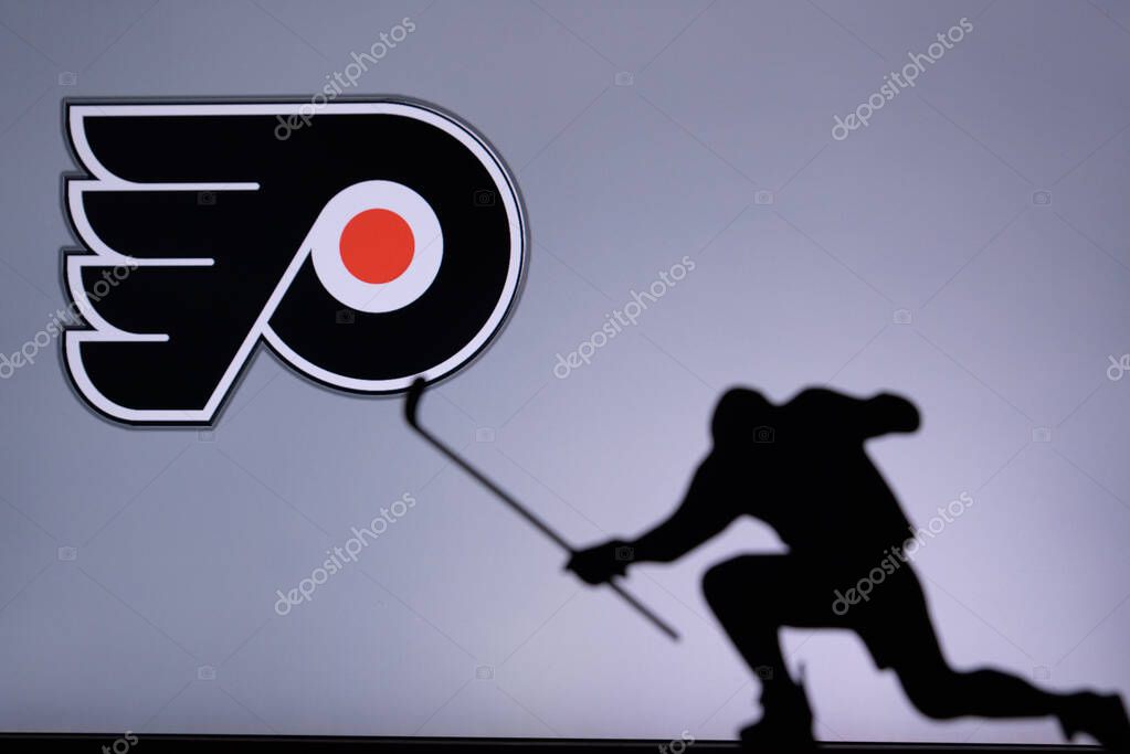 TORONTO, CANADA, 17. JULY: Philadelphia Flyers Logo. Professional NHL hockey player celebrate goal. Silhouette photo, Edit space