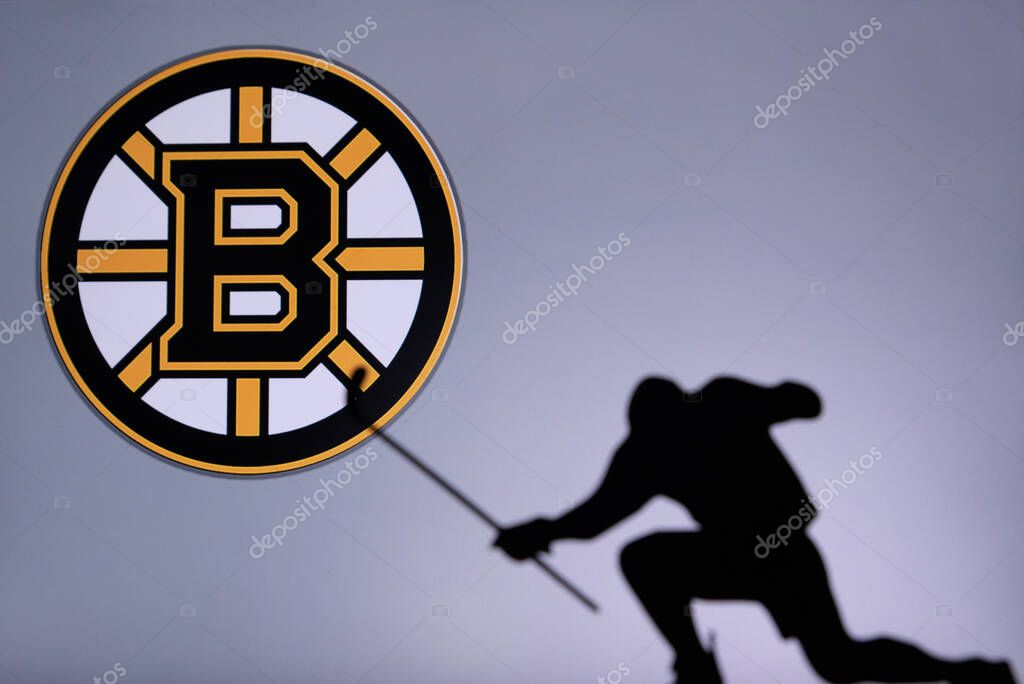 TORONTO, CANADA, 17. JULY: Boston Bruins Logo. Professional NHL hockey player celebrate goal. Silhouette photo, Edit space