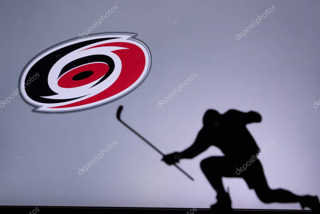 TORONTO, CANADA, 17. JULY: Carolina Hurricanes Logo. Professional NHL hockey player celebrate goal. Silhouette photo, Edit space