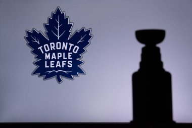 TORONTO, CANADA, 17. JULY: Toronto Maple LeafsLogo of NHL club on the screen. Stenley Cup Trophy Silhouette. clipart