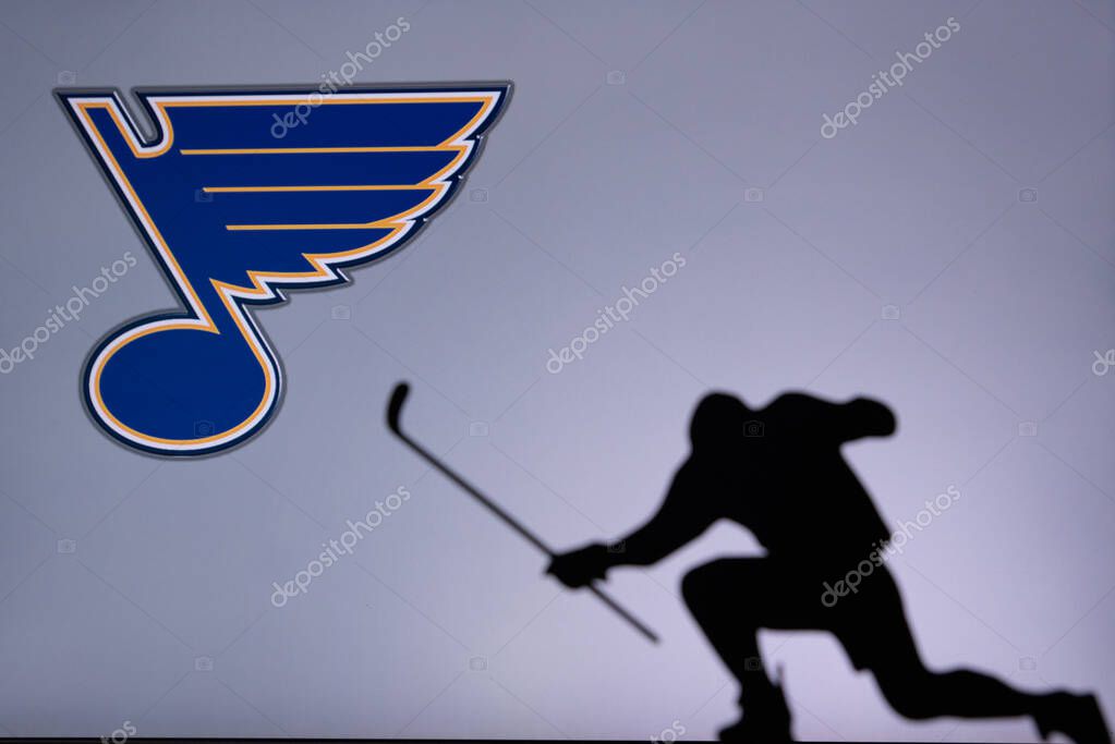 TORONTO, CANADA, 17. JULY: St. Louis Blues Logo. Professional NHL hockey player celebrate goal. Silhouette photo, Edit space