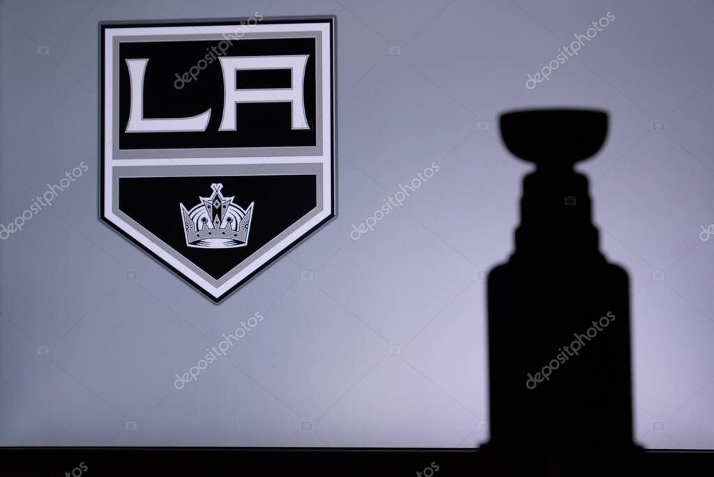 TORONTO, CANADA, 17. JULY: Los Angeles KingsLogo of NHL club on the screen. Stenley Cup Trophy Silhouette.