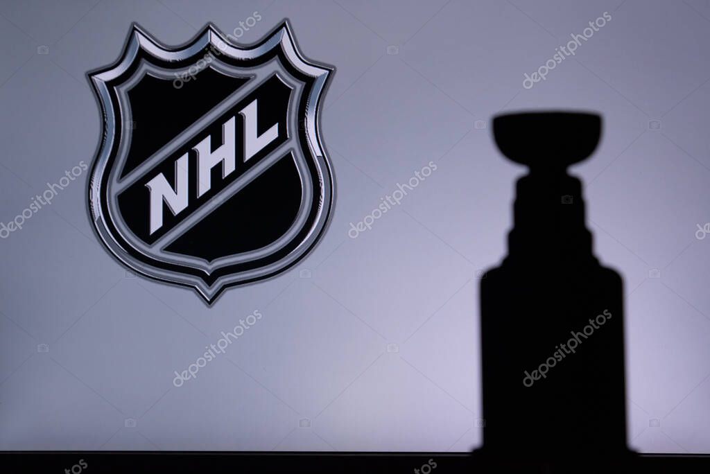TORONTO, CANADA, 17. JULY: National Hockey LeagueLogo of NHL club on the screen. Stenley Cup Trophy Silhouette.