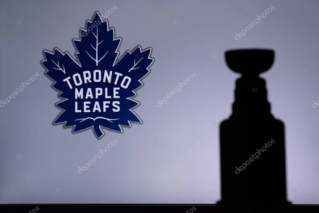 TORONTO, CANADA, 17. JULY: Toronto Maple LeafsLogo of NHL club on the screen. Stenley Cup Trophy Silhouette.