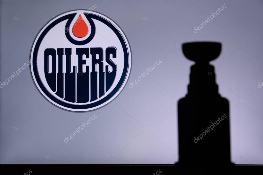 TORONTO, CANADA, 17. JULY: Edmonton OilersLogo of NHL club on the screen. Stenley Cup Trophy Silhouette.