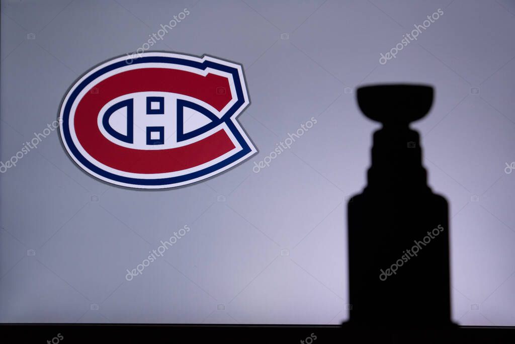 TORONTO, CANADA, 17. JULY: Montreal CanadiensLogo of NHL club on the screen. Stenley Cup Trophy Silhouette.