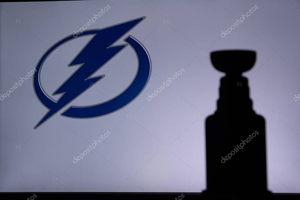 TORONTO, CANADA, 17. JULY: Tampa Bay LightningLogo of NHL club on the screen. Stenley Cup Trophy Silhouette.