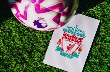 VIENNA, AUSTRIA, MAY 26, 2025: Liverpool logo of football club of Premier League. Official ball for season 2025 and 2026. And logo of soccer club in major British league on green grass