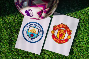 VIENNA, AUSTRIA, MAY 26, 2025: Manchester City vs Manchester United derby football match in Premier League. Club logo and official ball on green soccer grass. Manchester Derby