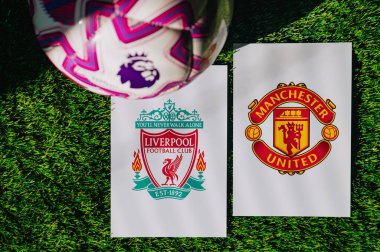 VIENNA, AUSTRIA, MAY 26, 2025: Liverpool vs Manchester United derby football match in Premier League. Club logo and official ball on green soccer grass. Northwest Derby