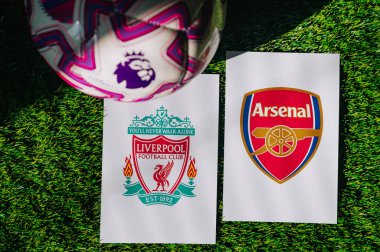 VIENNA, AUSTRIA, MAY 26, 2025: Liverpool vs Arsenal derby football match in Premier League. Club logo and official ball on green soccer grass.