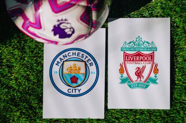 VIENNA, AUSTRIA, MAY 26, 2025: Manchester City vs Liverpool derby football match in Premier League. Club logo and official ball on green soccer grass.