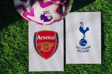 VIENNA, AUSTRIA, MAY 26, 2025: Arsenal vs Tottenham Hotspur derby football match in Premier League. Club logo and official ball on green soccer grass.