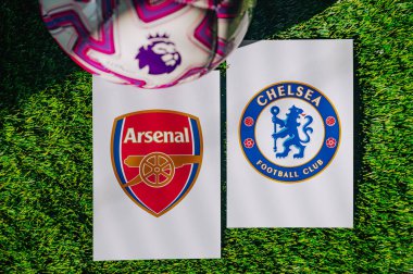 VIENNA, AUSTRIA, MAY 26, 2025: Arsenal vs Chelsea derby football match in Premier League. Club logo and official ball on green soccer grass.