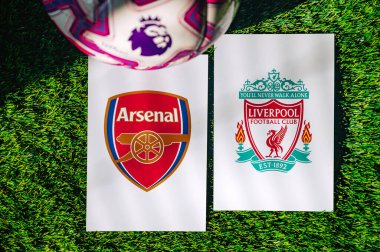VIENNA, AUSTRIA, MAY 26, 2025: Arsenal vs Liverpool derby football match in Premier League. Club logo and official ball on green soccer grass.