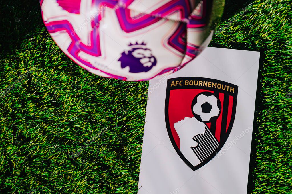 VIENNA, AUSTRIA, MAY 26, 2025: Bournemouth logo of football club of Premier League. Official ball for season 2025 and 2026. And logo of soccer club in major British league on green grass