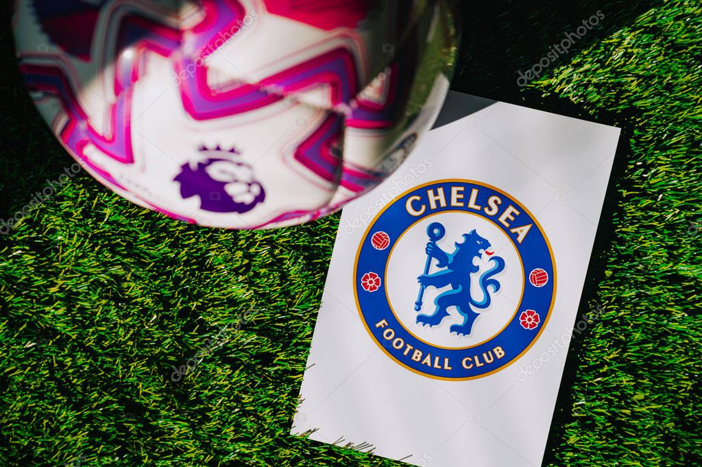 VIENNA, AUSTRIA, MAY 26, 2025: Chelsea logo of football club of Premier League. Official ball for season 2025 and 2026. And logo of soccer club in major British league on green grass