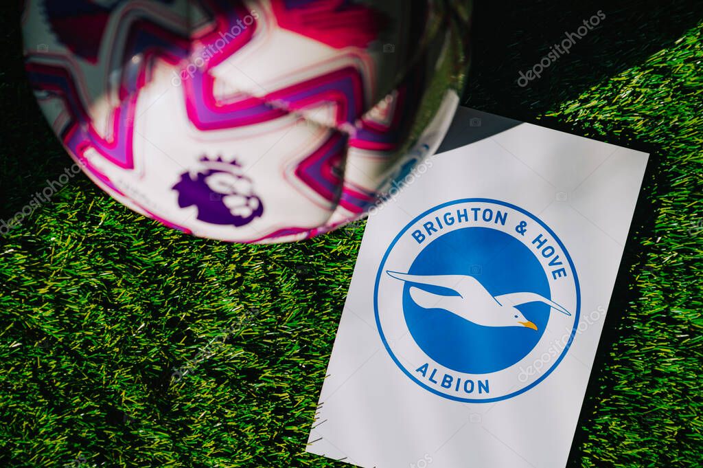 VIENNA, AUSTRIA, MAY 26, 2025: Brighton & Hove Albion logo of football club of Premier League. Official ball for season 2025 and 2026. And logo of soccer club in major British league on green grass