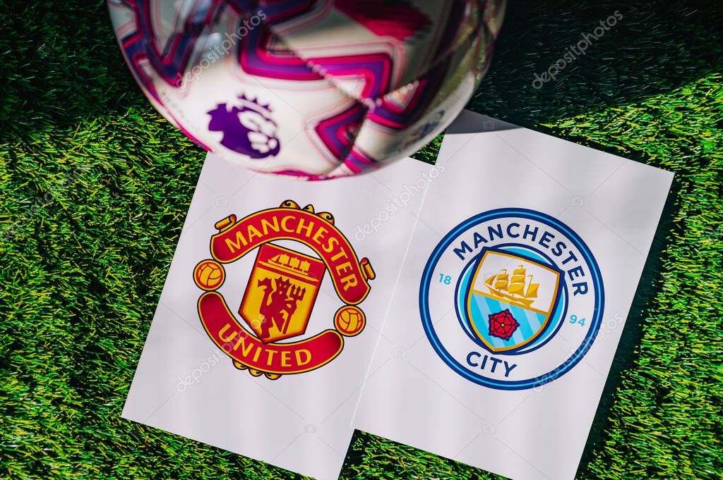 VIENNA, AUSTRIA, MAY 26, 2025: Manchester United vs Manchester City derby football match in Premier League. Club logo and official ball on green soccer grass. Manchester Derby.