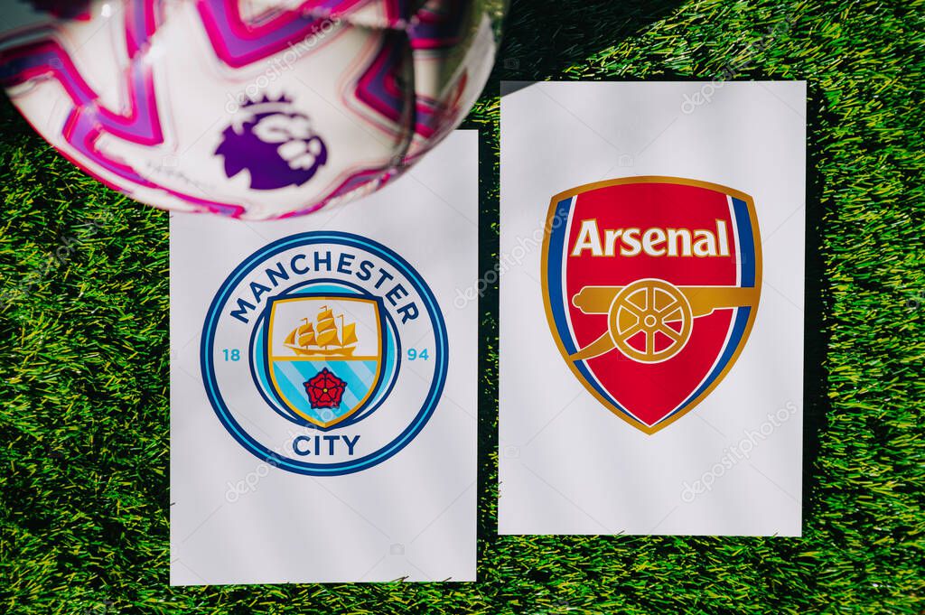 VIENNA, AUSTRIA, MAY 26, 2025: Manchester City vs Arsenal derby football match in Premier League. Club logo and official ball on green soccer grass.