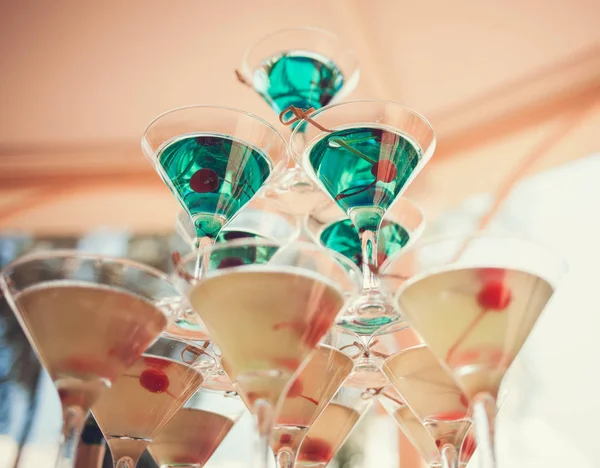 colorful pyramid of martini glasses with olives