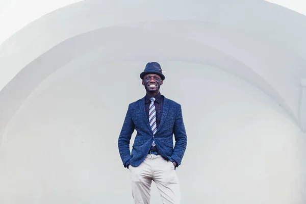 fashionable african man in suit with tie and hat