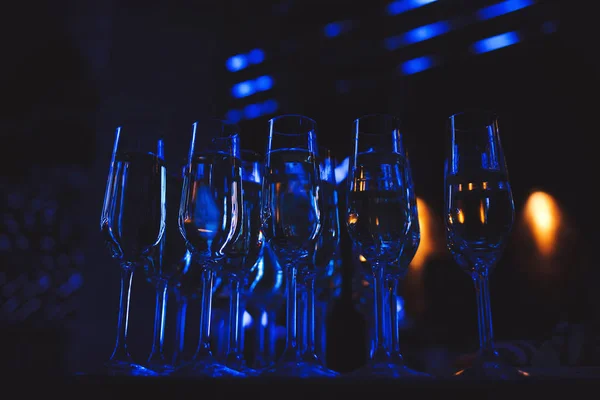 Glasses with wine on dark blurred background