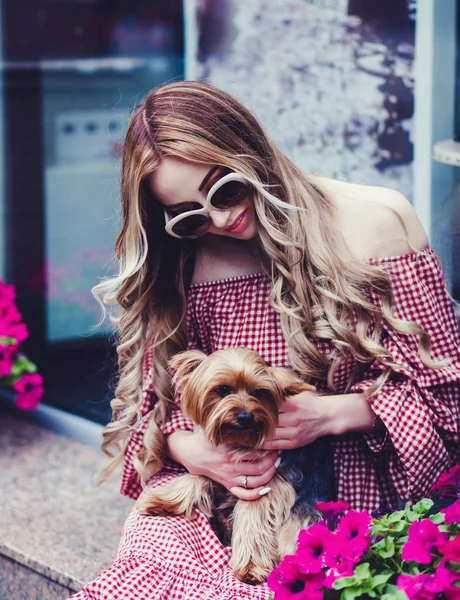 woman holding a small dog