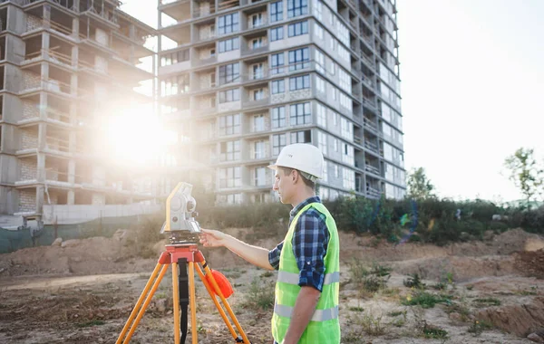 surveyor engineer with theodolite transit equipment