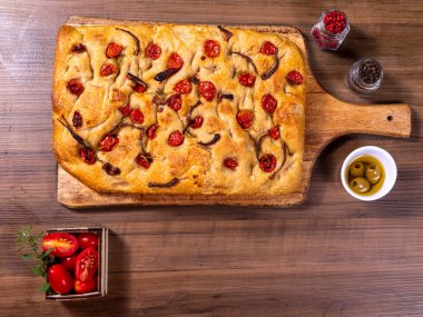 Çeri domatesli, siyah zeytinli ve biberiyeli geleneksel İtalyan Focaccia