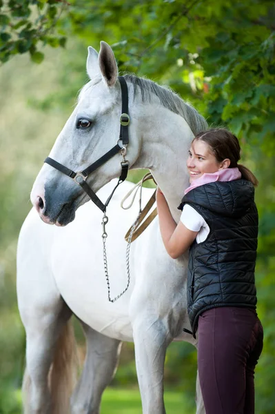 Young cheerful lady coach with her favorite white horse — Stock Photo, Image
