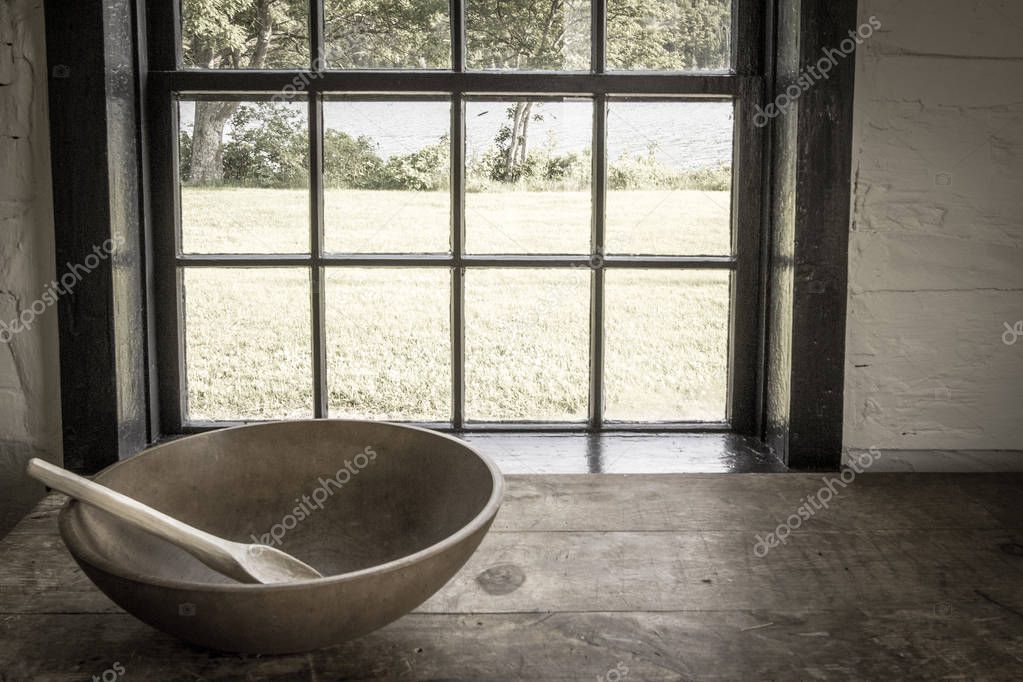 Country Kitchen Interior. Rustic style kitchen with wooden spoon and bowl on antique wooden table