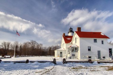 Winter Lighthouse Landscape. The Point Iroquois Lighthouse on the shores of Lake Superior is a federally owned navigational beacon in the Hiawatha National Forest and is open to the public as a museum clipart