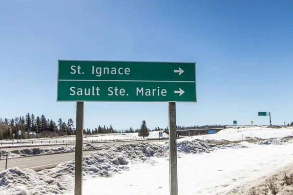 Upper Peninsula Michigan Winter. Interstate 75 sign for the towns of St. Ignace and Sault Ste Marie Michigan in the UP of Michigan on a sunny winter day. I 75 is the Upper Peninsulas only freeway.