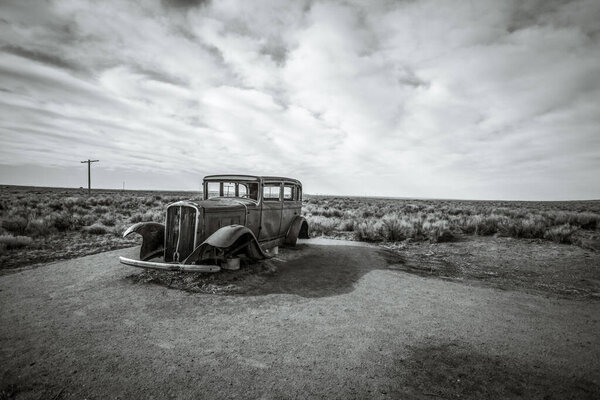 Abandoned vintage car rusting in the desert of the American southwest. 