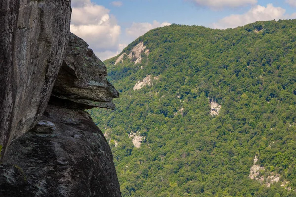 Devils Head rock on the edge a steep cliff at Chimney Rock State Park in the Appalachian Mountains of North Carolina.