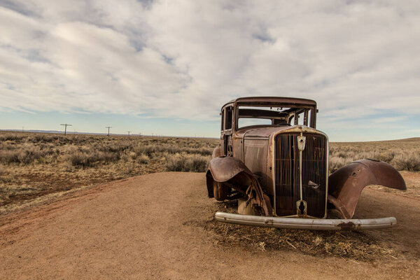 Abandoned Car in the American southwest desert at the Petrified Forest Painted Desert National Park. 