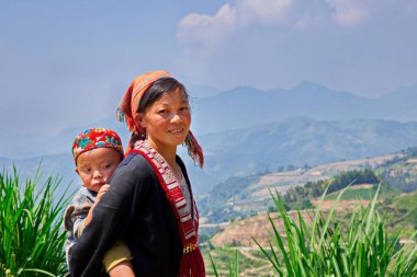 Ha Giang, Vietnam-Mayıs 29, 2017-etnik anne ve onun çocuk dağ üzerinde olgunlaşabilir pirinç terasları yakın.