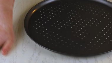 Fresh raw pizza dough on oven tray.