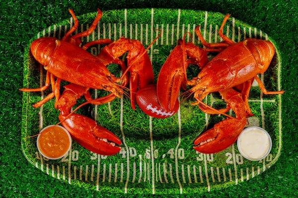 Two Red Cooced Lobsters Green Plate Football Ball American Football — Stock Photo, Image