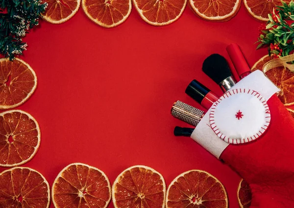 dried orange peel, dried orange frame on a red background. space for text.the view from the top. copy space. the view from the top. dried orange peels. The concept of a holiday, celebration and cooking. new year and Christmas card.Christmas gifts for