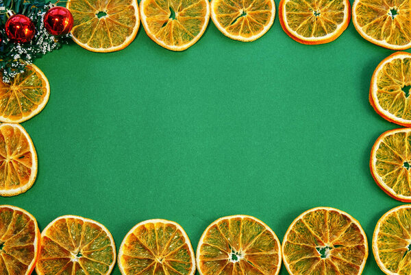 dried orange frame on green background. space for text.the view from the top. copy space. the view from the top. gift