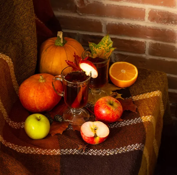 Autumn fall Halloween Thanksgiving season special mulled wine hot cocktail. A photo composition with maple leaves, apples, pumpkins and orange in front of the brick wall. — Stock Photo, Image