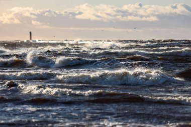 Büyük fırtına dalgalarıyla Baltık deniz fenerine doğru rüzgarlı bir gece yarısı manzarası. Fotoğraf Letonya 'da çekildi.