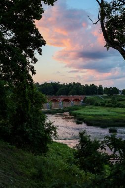 Eski tuğla köprüyle gün batımı manzarası. Fotoğraf Avrupa 'da çekildi.