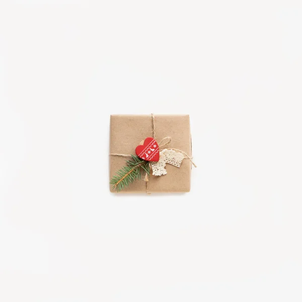 Christmas gift in kraft paper isolated on white background. Eco and natural wrapping. — Stock Photo, Image