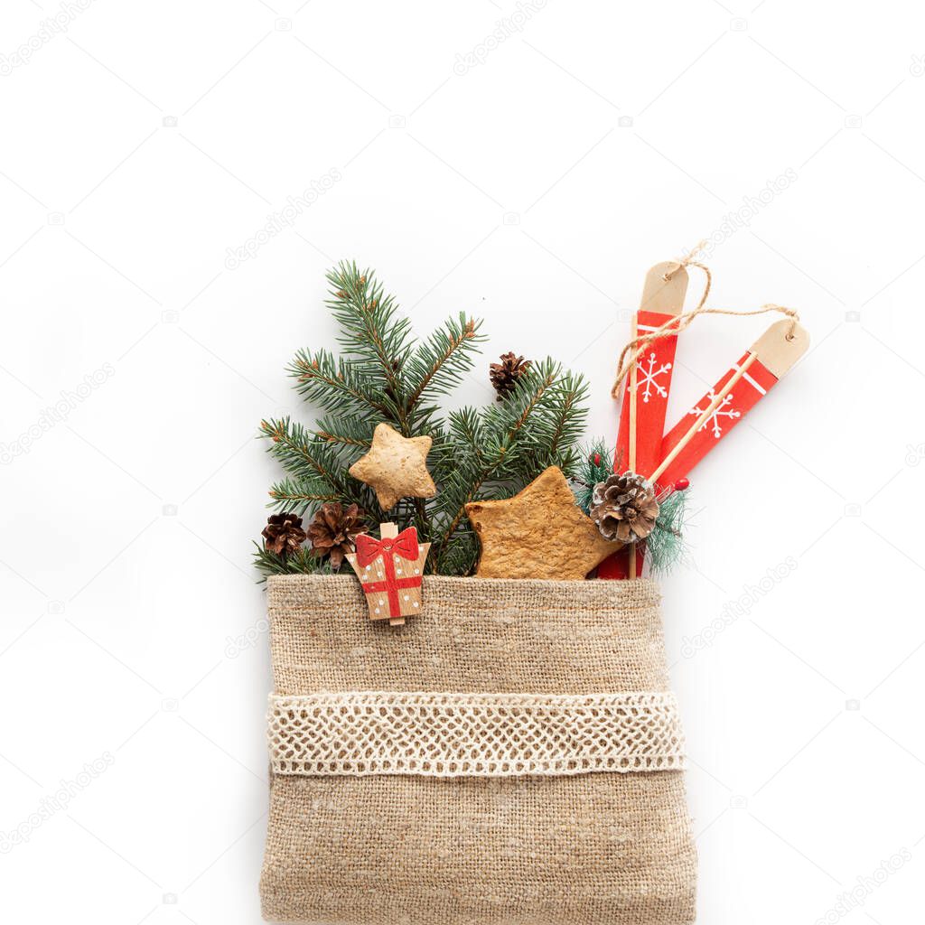 Zero waste Christmas composition. Pine branches and gift into the sackcloth bag.