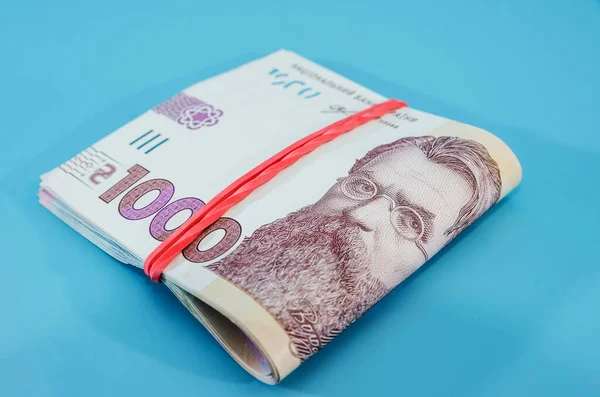 Bankbiljetten Worden Opgerold Een Close 1000 Hryvnia Een Blauwe Achtergrond — Stockfoto