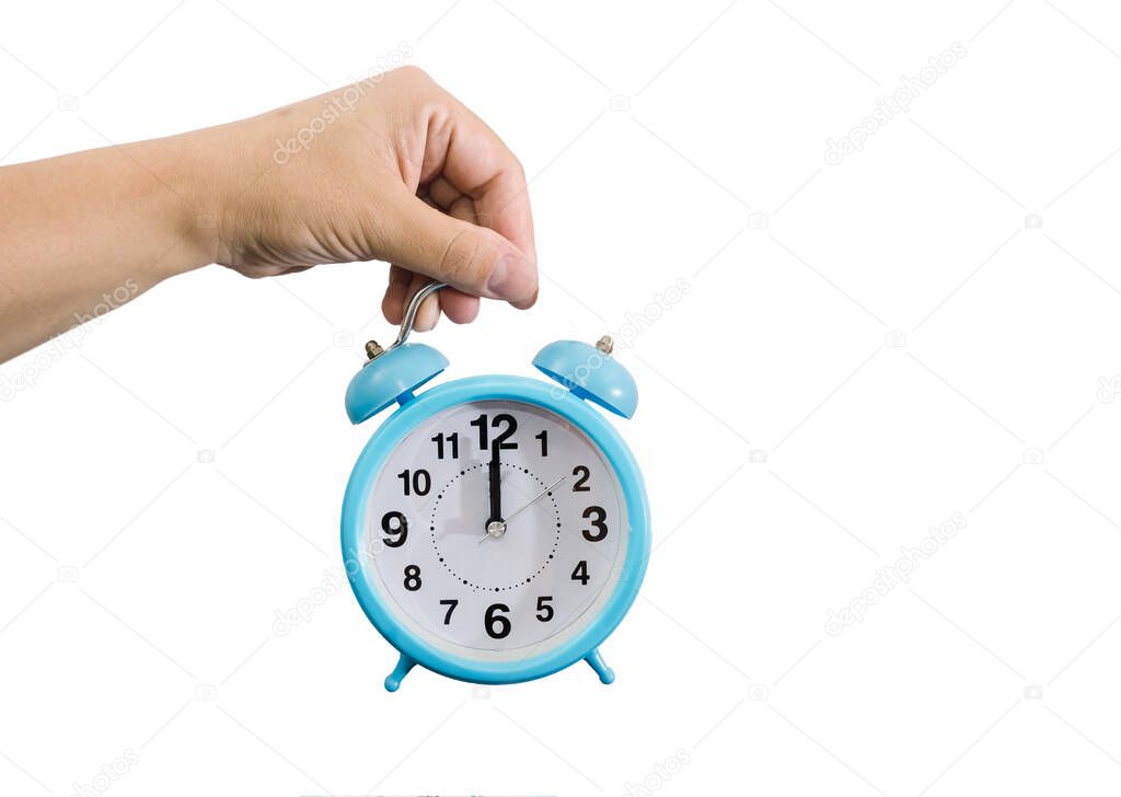 blue alarm clock in a female hand isolated on a white background. Copy of space. Midnight on the alarm clock.