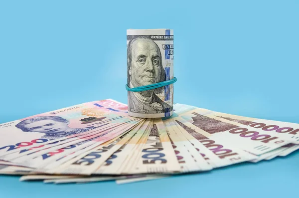 Rullade Upp 100 Dollarsedlar Och Ukrainska Hryvnia Blå Bakgrund Finansiellt — Stockfoto